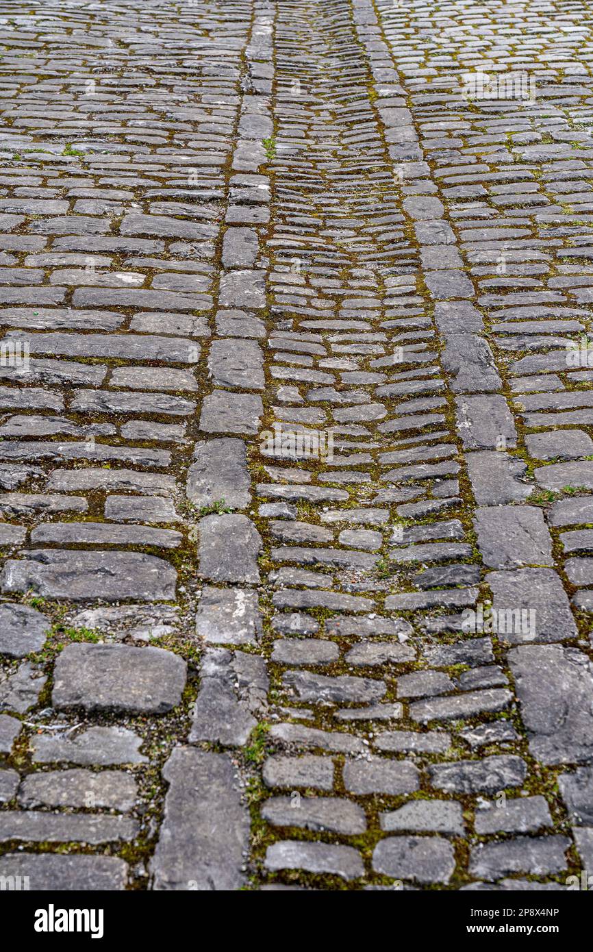 Street with gray paving stone through the historical town Stock Photo