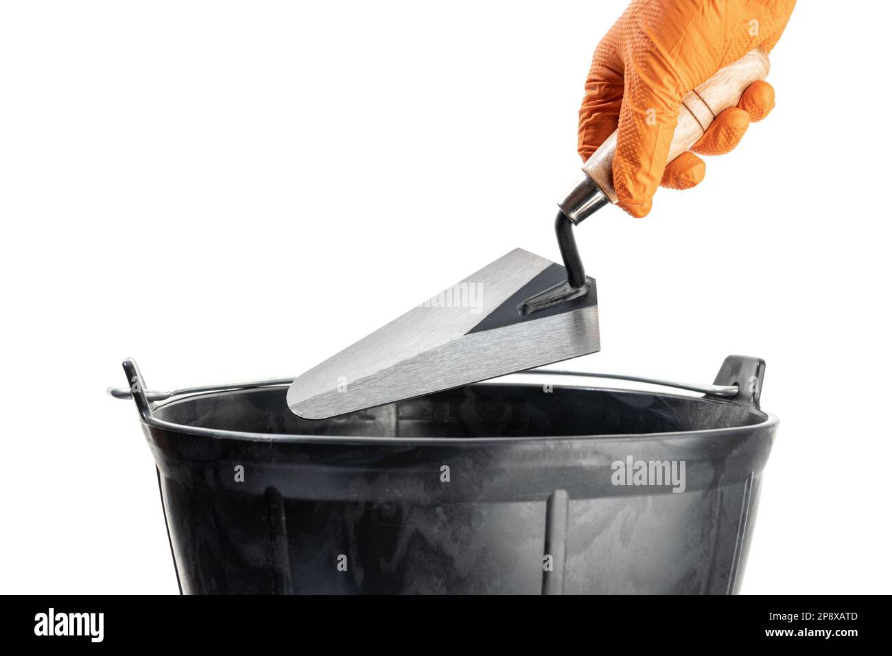 Hand Holding a Trowel over a mason bucket isolated on White Background