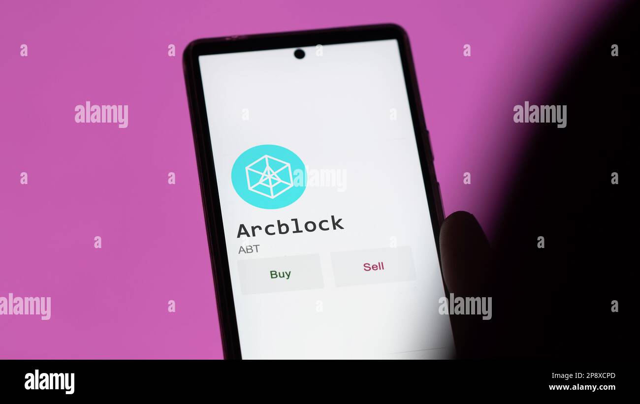 An investor's analyzing the Arcblock ABT coin on screen. A phone shows ...