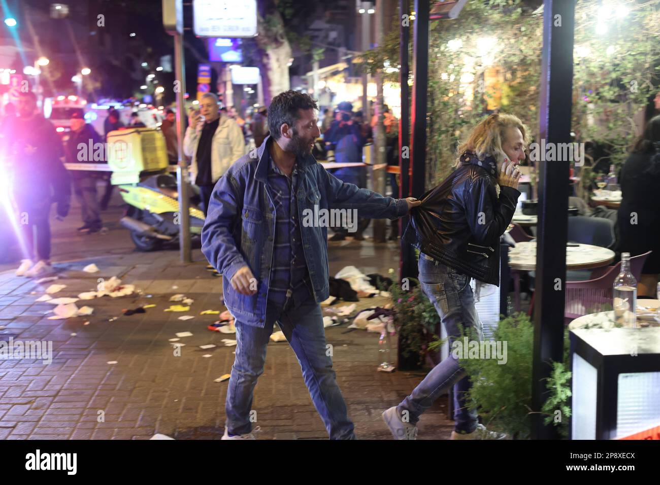 Tel Aviv, Israel. 09th Mar, 2023. People stand at the scene after a shooting attack near a cafe at Dizengoff Street. At least three Israeli civilians were injured by gunshots. Credit: Ilia Yefimovich/dpa/Alamy Live News Stock Photo