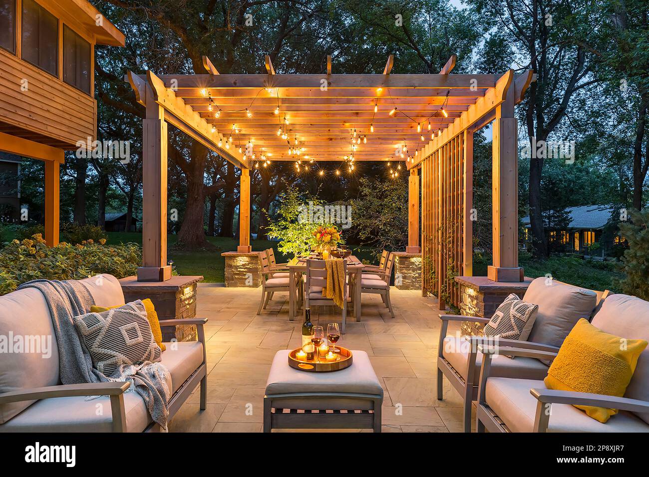 Pergola on patio is lit up with bright string lights on a summer evening  Stock Photo - Alamy