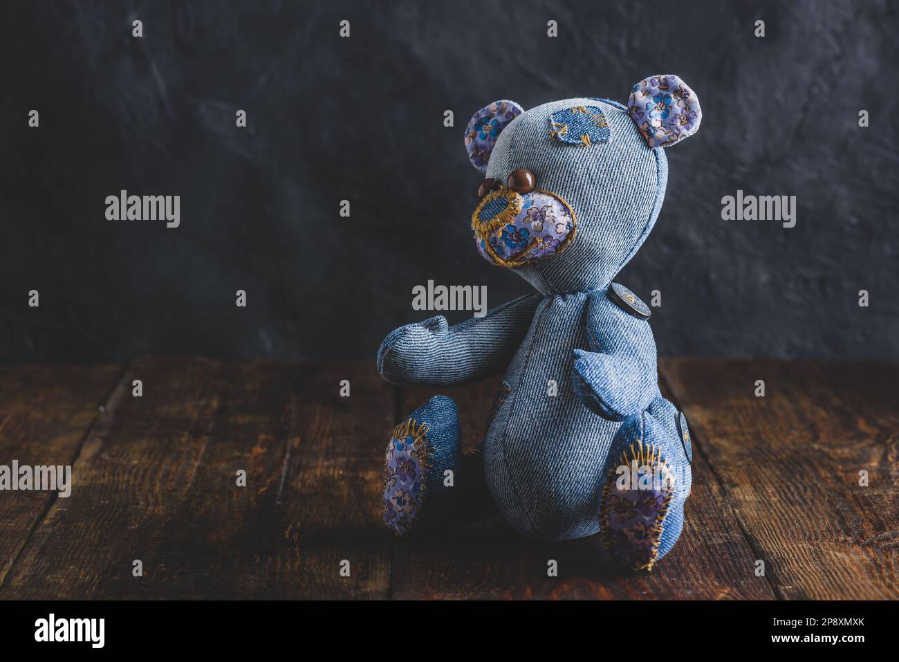 Handmade Teddy Bear Sitting on Wooden Table Stock Photo