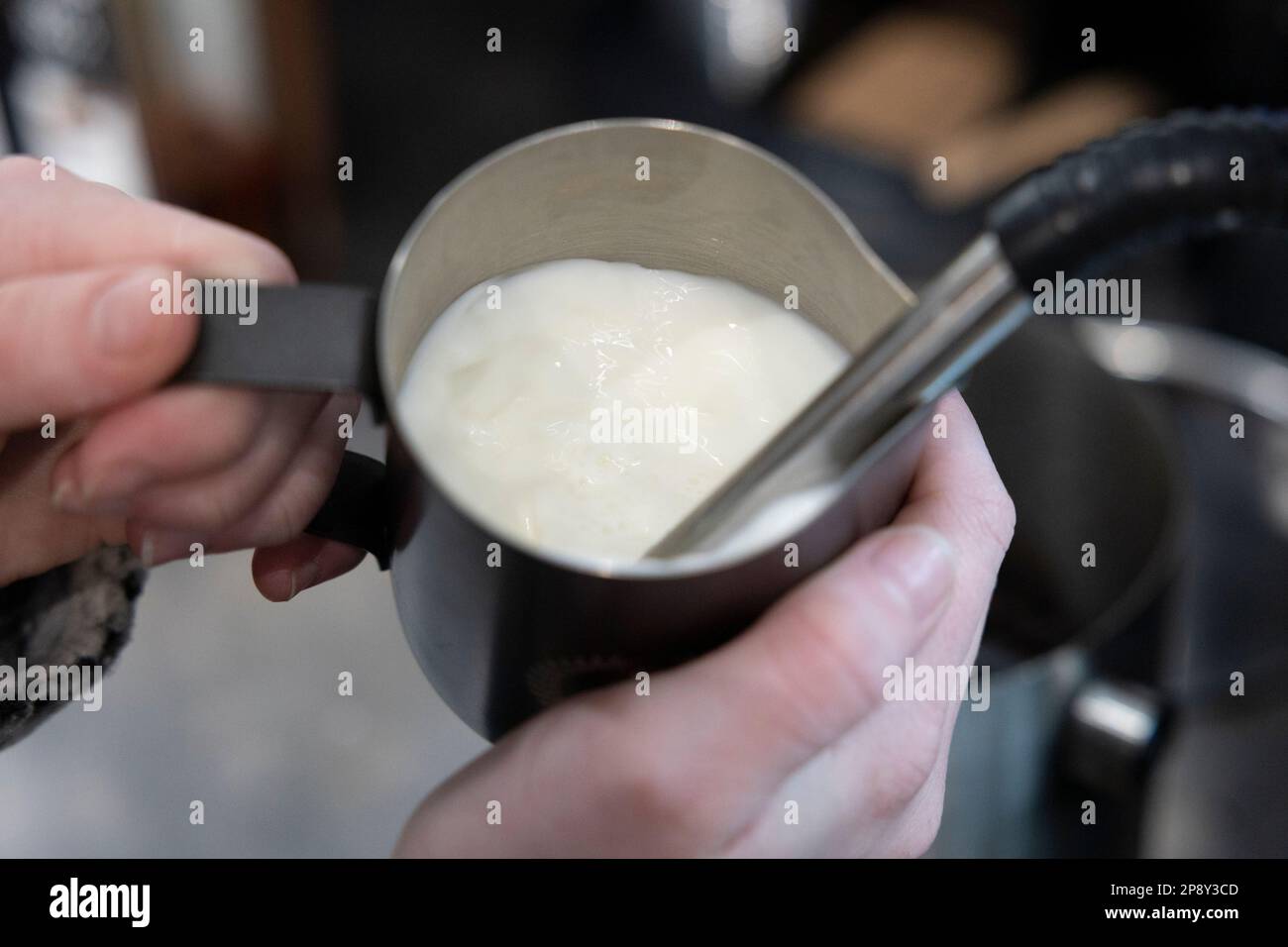 https://c8.alamy.com/comp/2P8Y3CD/milk-in-a-metal-cup-being-frothed-by-an-espresso-machine-steam-wand-2P8Y3CD.jpg