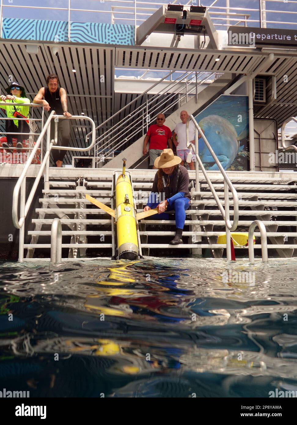 Slocum ocean glider (yellow) being deployed from Remora Tourism & Research Pontoon, Reef Magic, Great Barrier Reef near Cairns, Queensland, Australia. Stock Photo