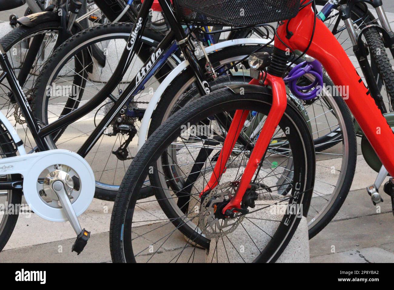 Bicycles parked in a cycle rack comprised of stone blocks, provided in one of the many piazzas found in Trieste, Northern Italy, September 2022. Stock Photo