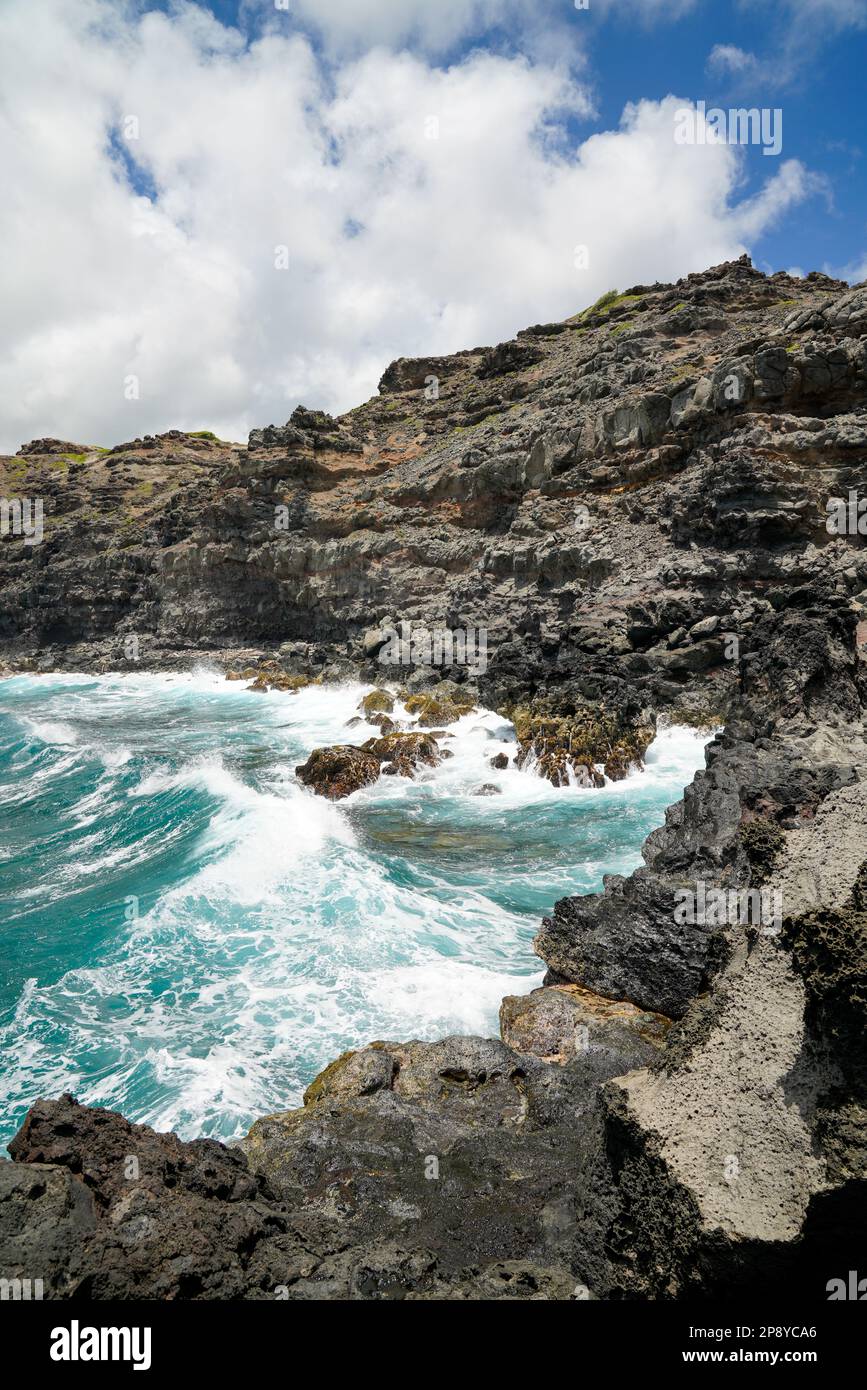 Set on the Maui's NW coast, Nakalele Blowhole is a natural geyser where seawater trapped in an underwater lava tube is searching for a way out. Stock Photo