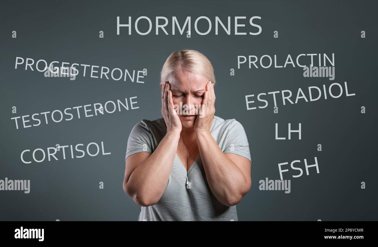 Hormones imbalance. Upset mature woman and different words on grey background Stock Photo Alamy