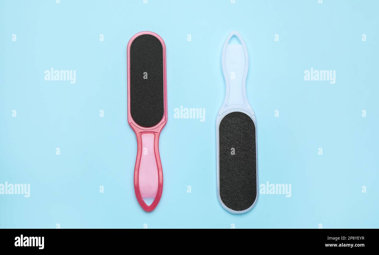 Foot files on light blue background, flat lay. Pedicure tools Stock Photo