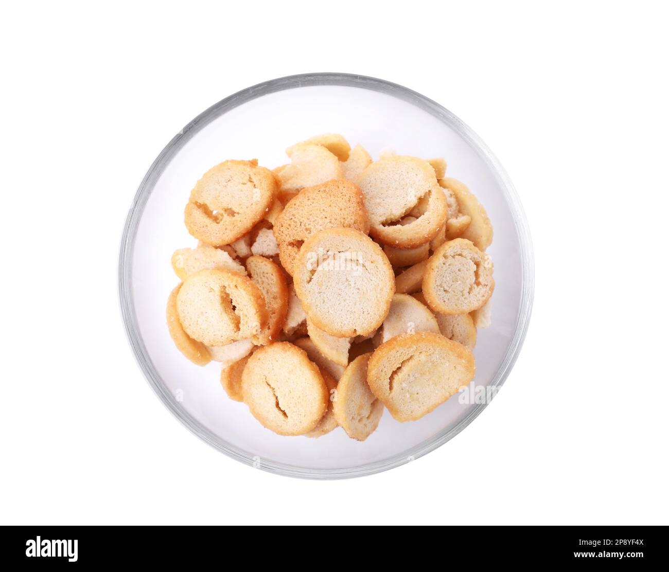 Delicious crispy rusks in glass bowl on white background, top view ...