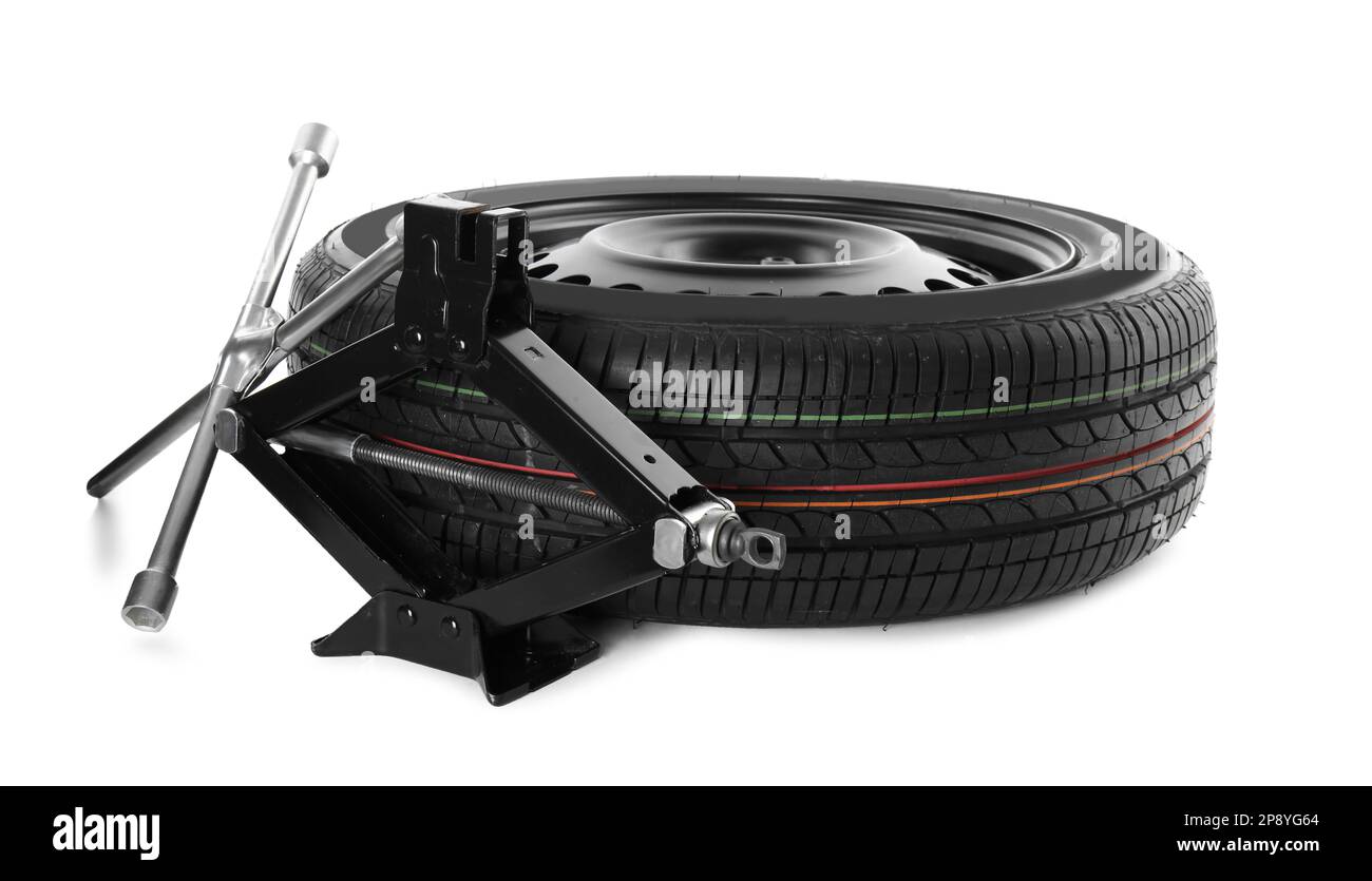 Car wheel, scissor jack and cross torque wrench on white background