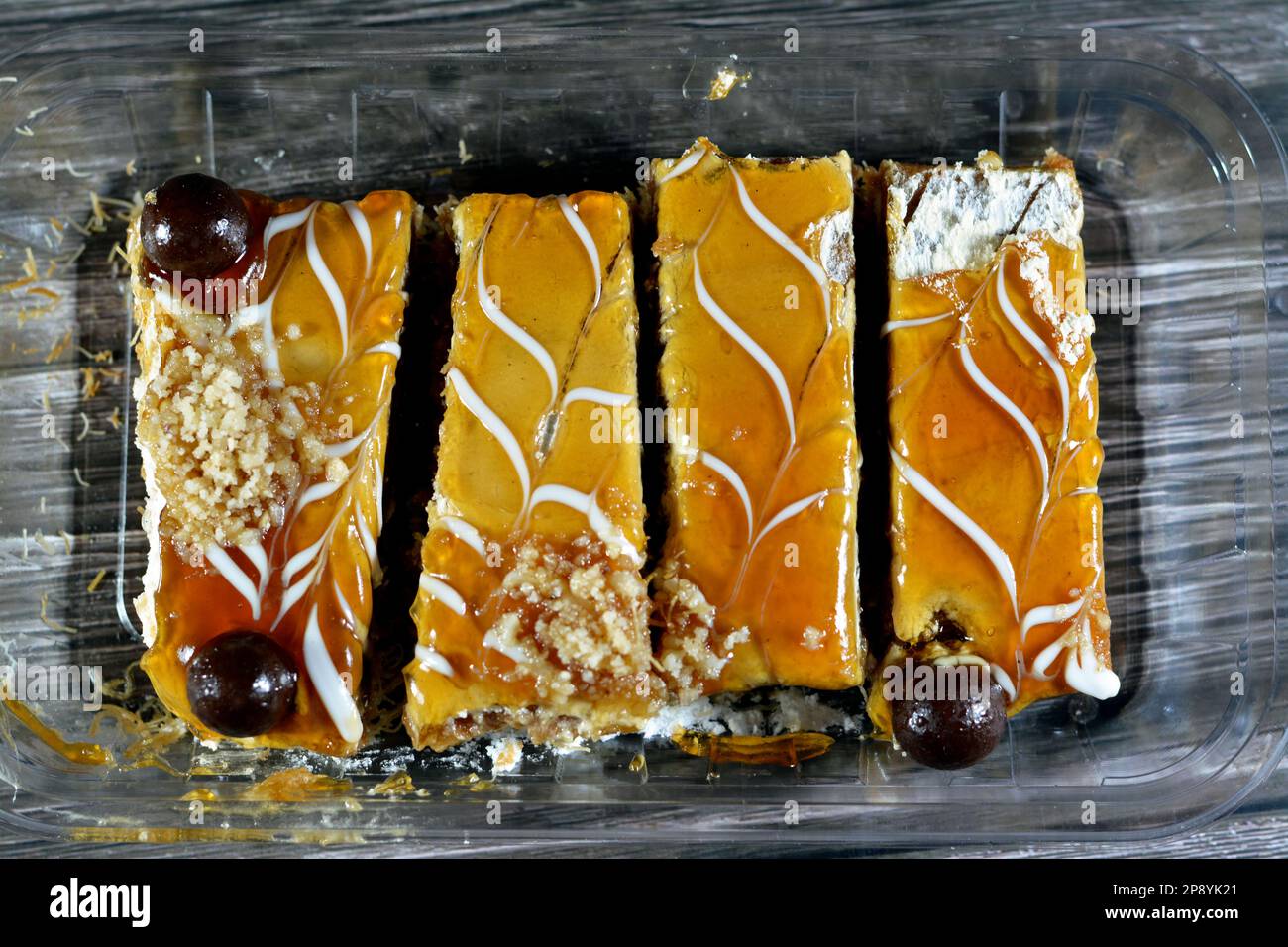 Egyptian dessert made of layers of basbousa semolina cake, kunafa