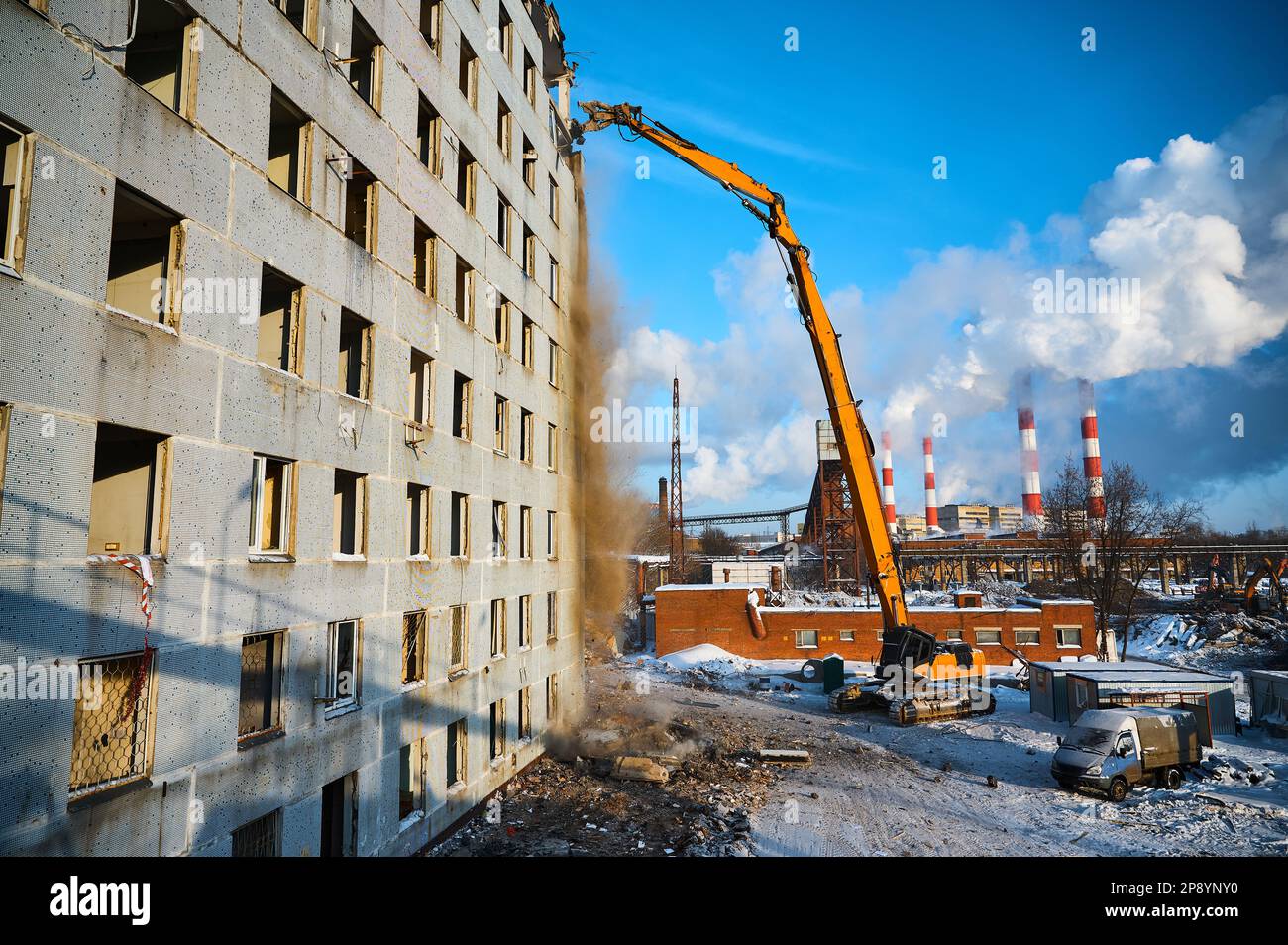 Building dismantling with high-altitude excavator destroyer Stock Photo
