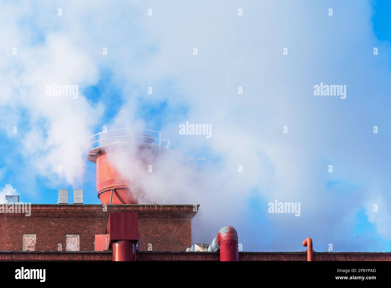White smoke coming out of factory chimney in Tampere Finland Stock Photo