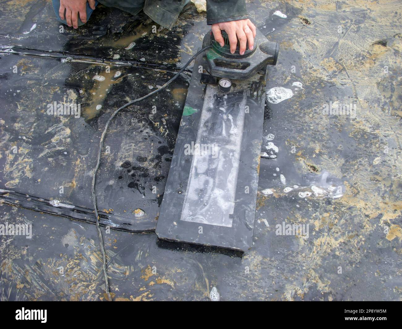 HDPE landfill liner patch installed on a bad weld seam being vacuum tested for leaks. Stock Photo