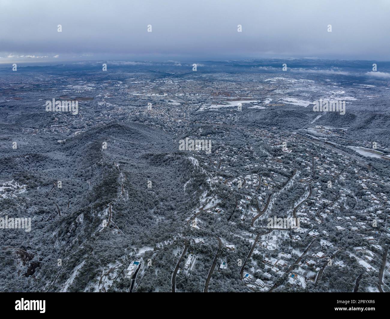 Aerial view of the snowy cities of Matadepera and Terrassa after the snowfall of 02-27-2023 (Vallès Occidental, Barcelona, Catalonia, Spain) Stock Photo