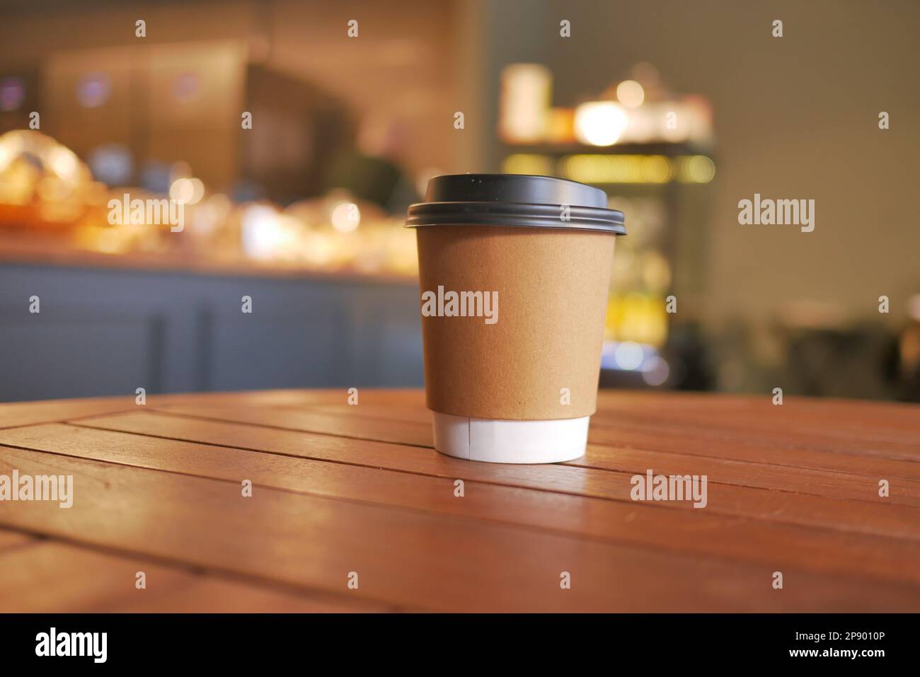 take away paper coffee cup o on cafe table Stock Photo - Alamy