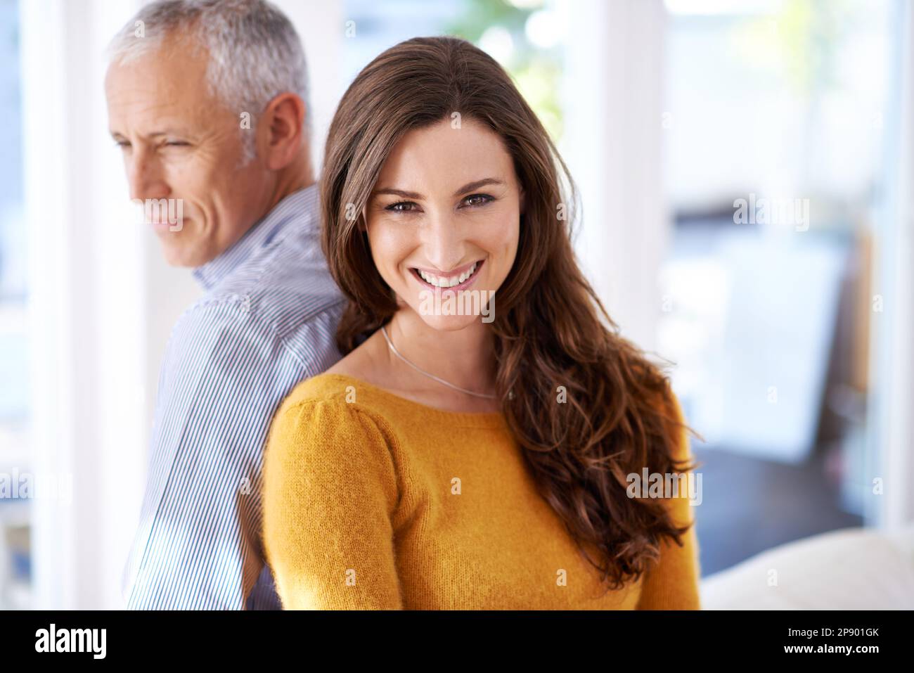 They have each others back. a mature man and his younger wife enjoying time at at home. Stock Photo
