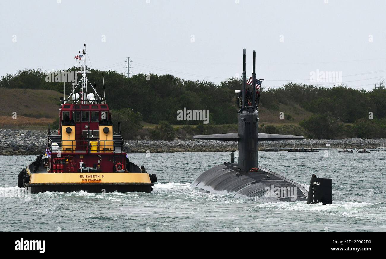 Port Canaveral, United States. 08th Mar, 2023. A tug guides a nuclear-powered U.S. Navy submarine into the Navy Port at Port Canaveral. According to U.S. officials, Australia is expected to purchase as many as five Virginia class nuclear-powered submarines from the United States to be delivered in the 2030ís pursuant to an agreement between the United States, Australia, and Great Britain. Credit: SOPA Images Limited/Alamy Live News Stock Photo