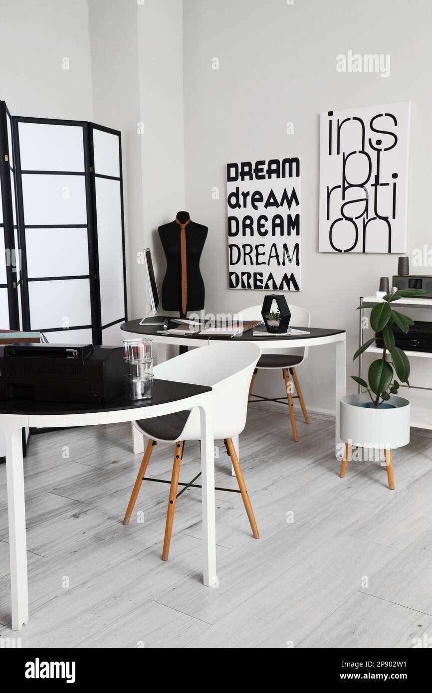 Interior of modern atelier with tables and mannequin Stock Photo Alamy