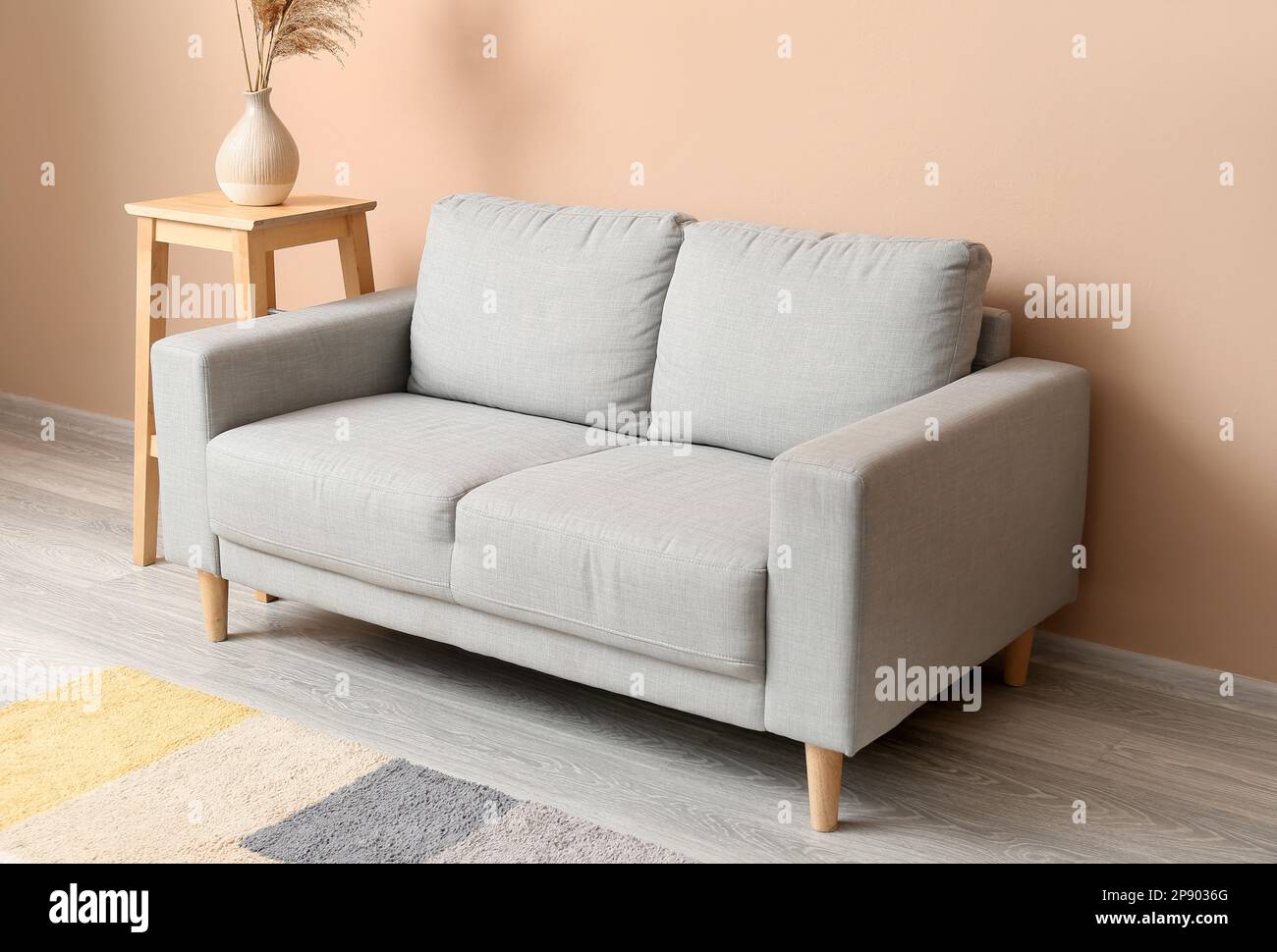 Interior of living room with grey couch and table Stock Photo - Alamy