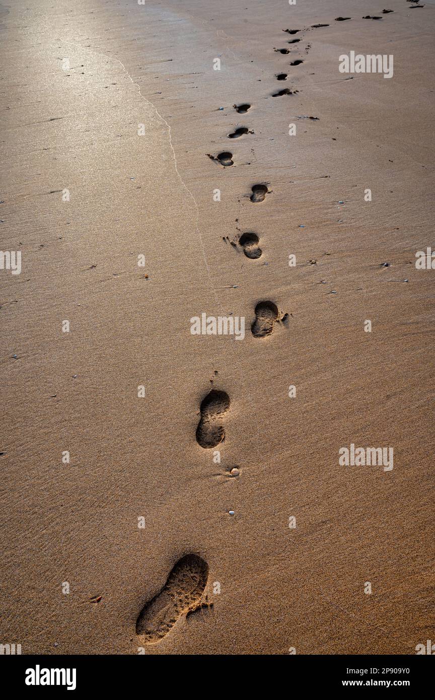 Single set of footprints in the sand on a beach in Ireland Stock Photo