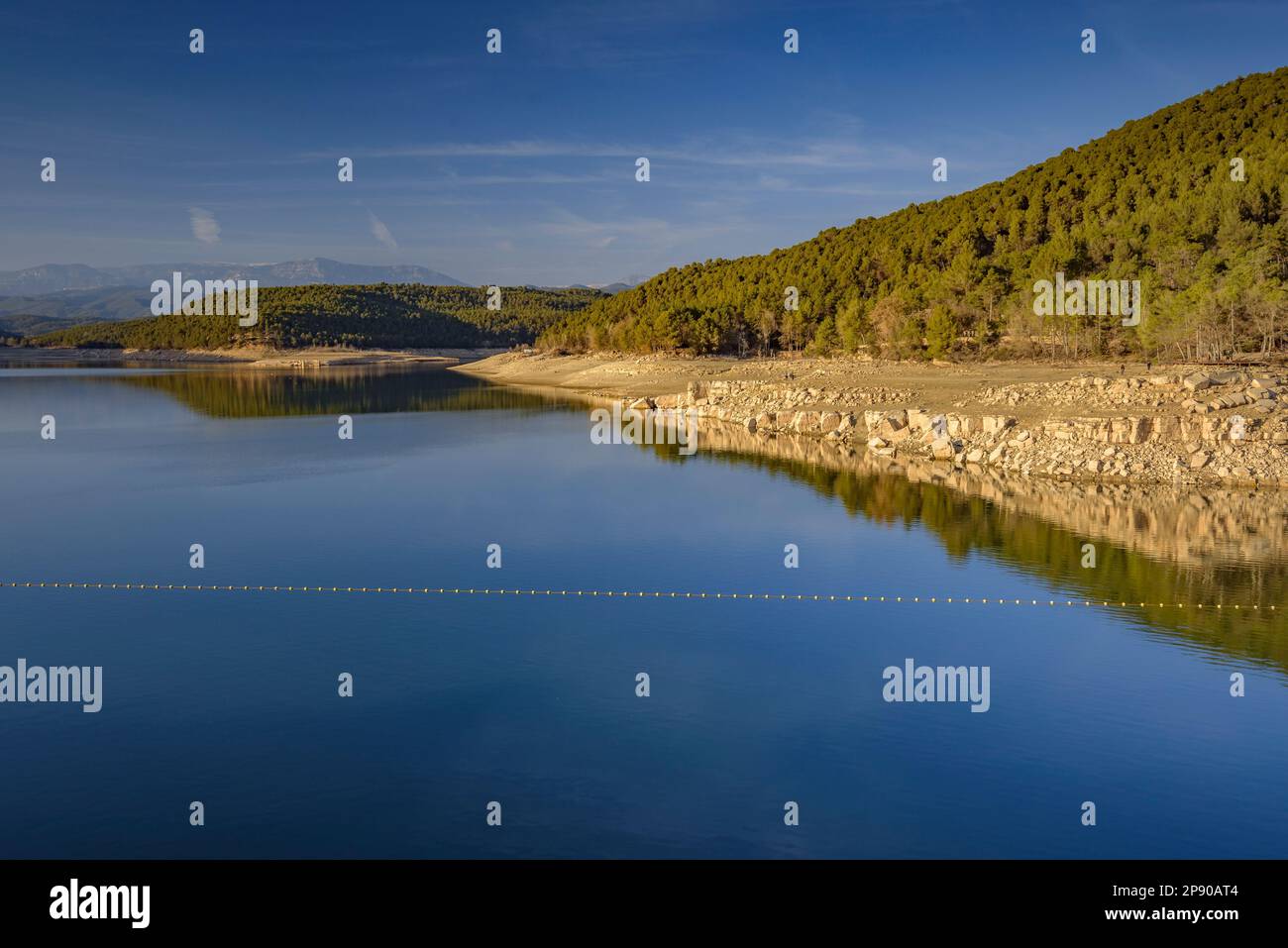 Sant Ponç Reservoir in a winter sunset with very low water level during