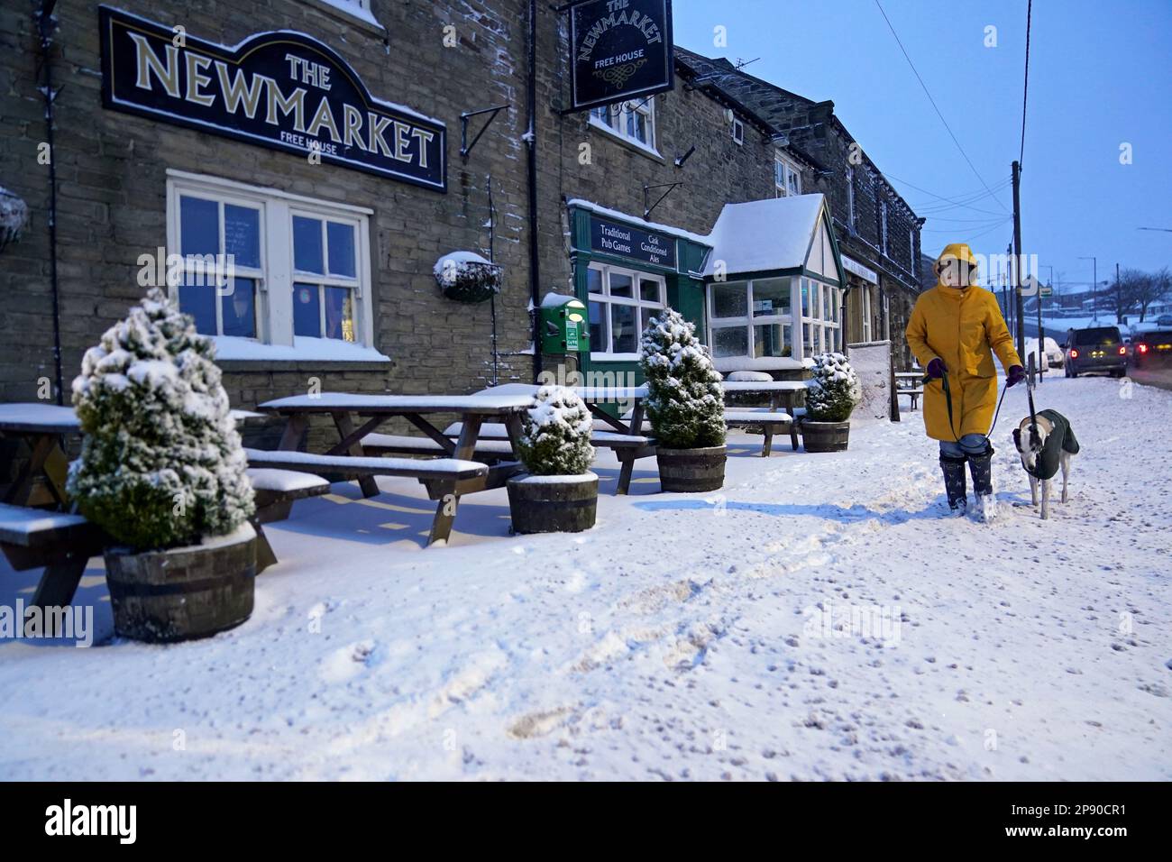 A woman walks her dog in Tow Law, Co Durham, after heavy overnight snow