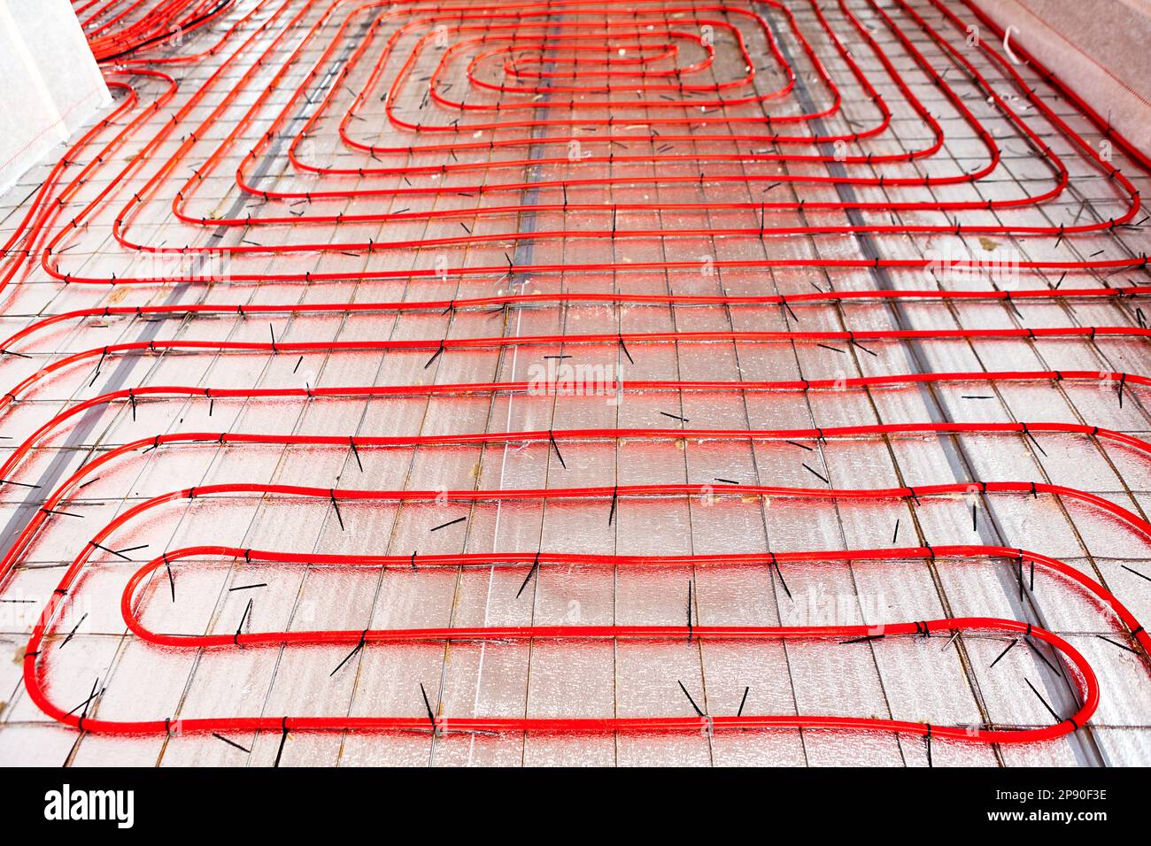 A XLPE pipe is laid for pouring the screed, underfloor heating Stock