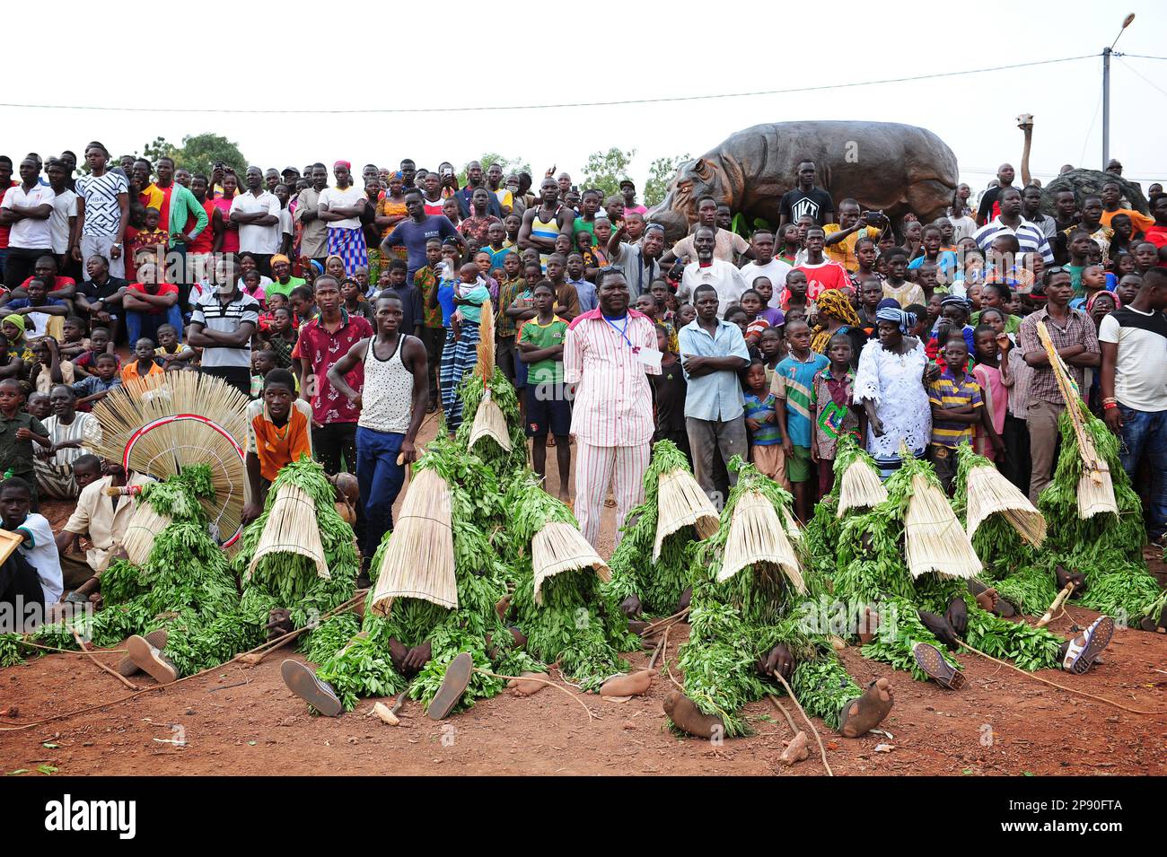 Leaf mask wearers wait to perform in front of the crowds at Festima