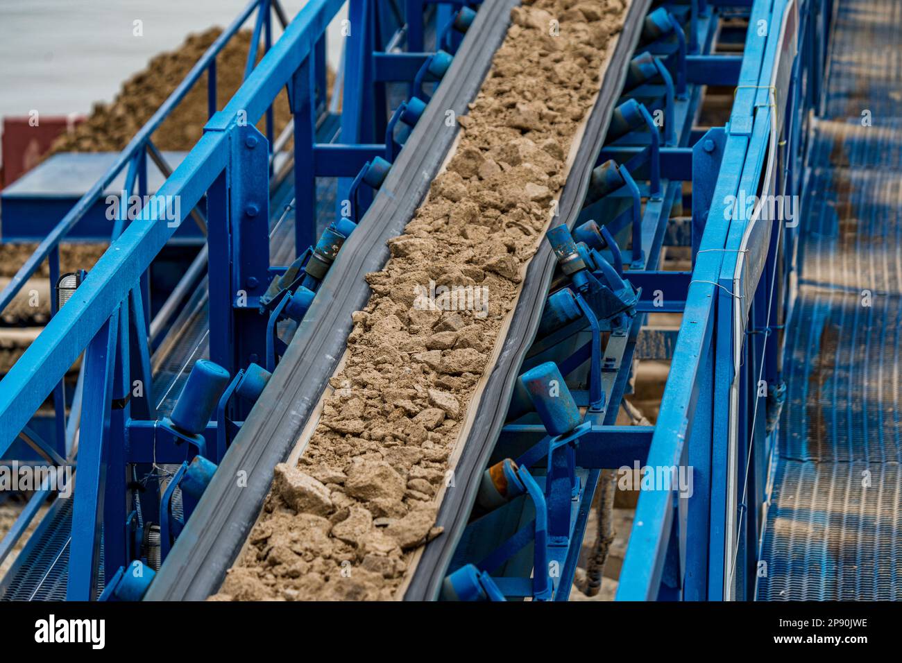 Industrial belt conveyor moving raw materials from mine Stock Photo Alamy
