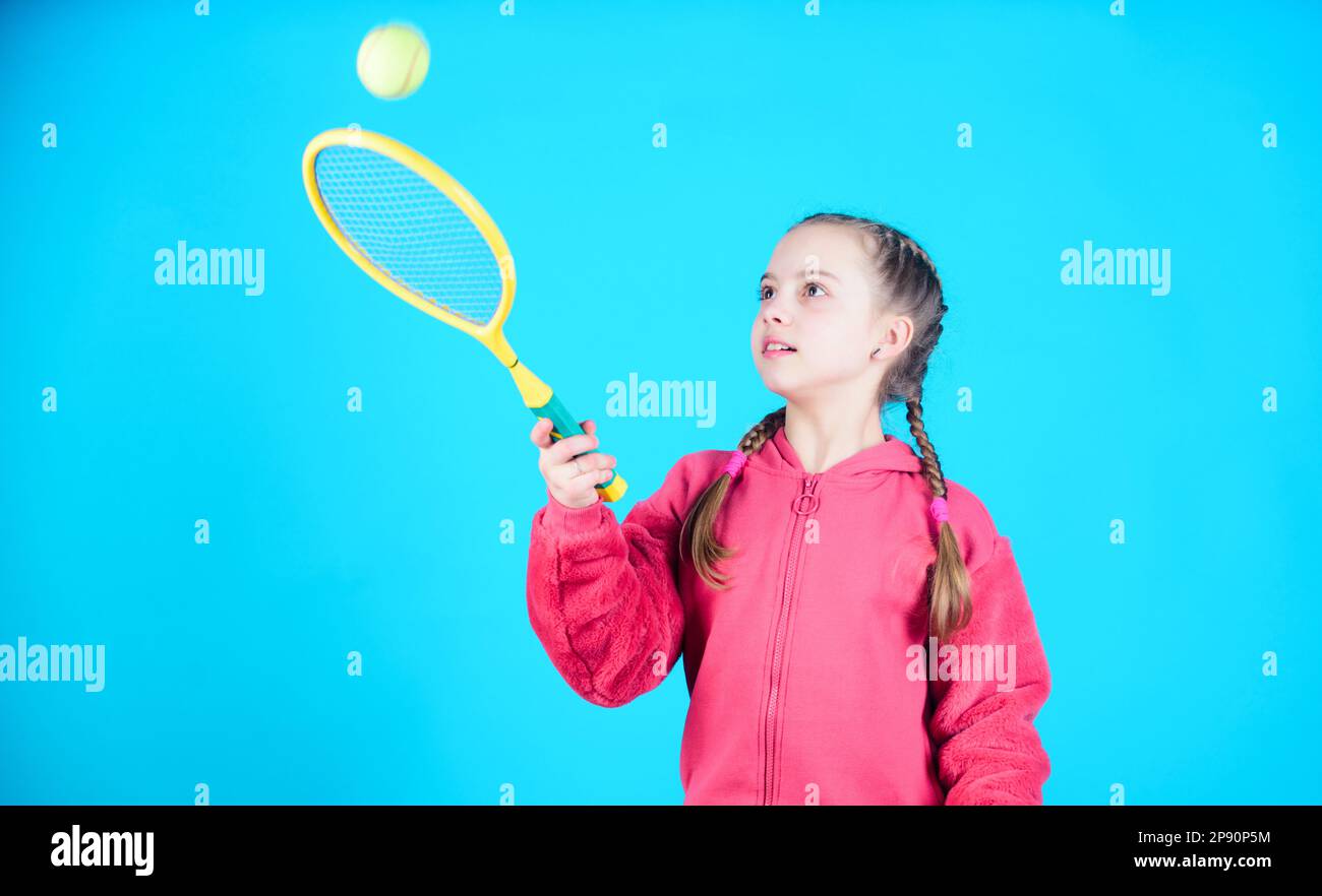 Tennis player with racket and ball. Childhood activity. Happy child play tennis. Gym workout of teen girl. Little girl. Fitness diet brings health and Stock Photo