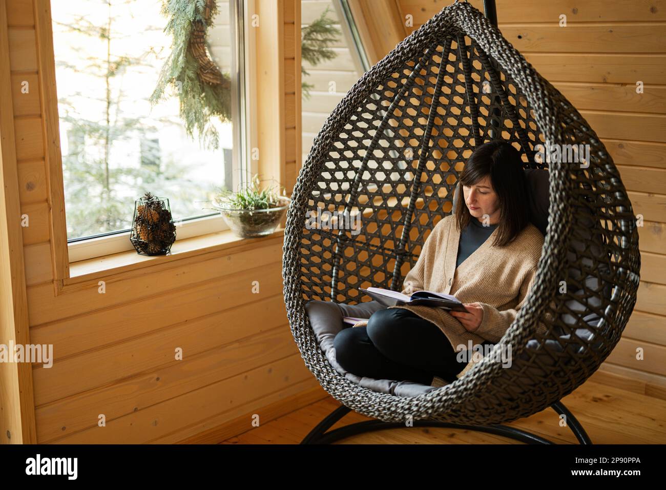 Remote work and escaping to nature concept. Woman sit in egg chair