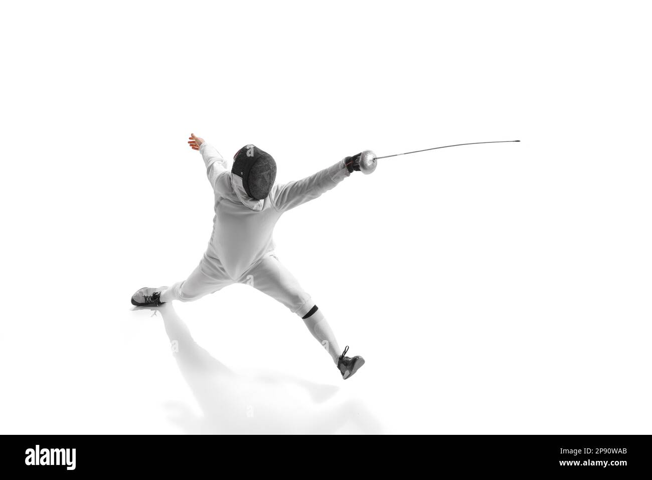 Professional male fencer in fencing costume training with sword