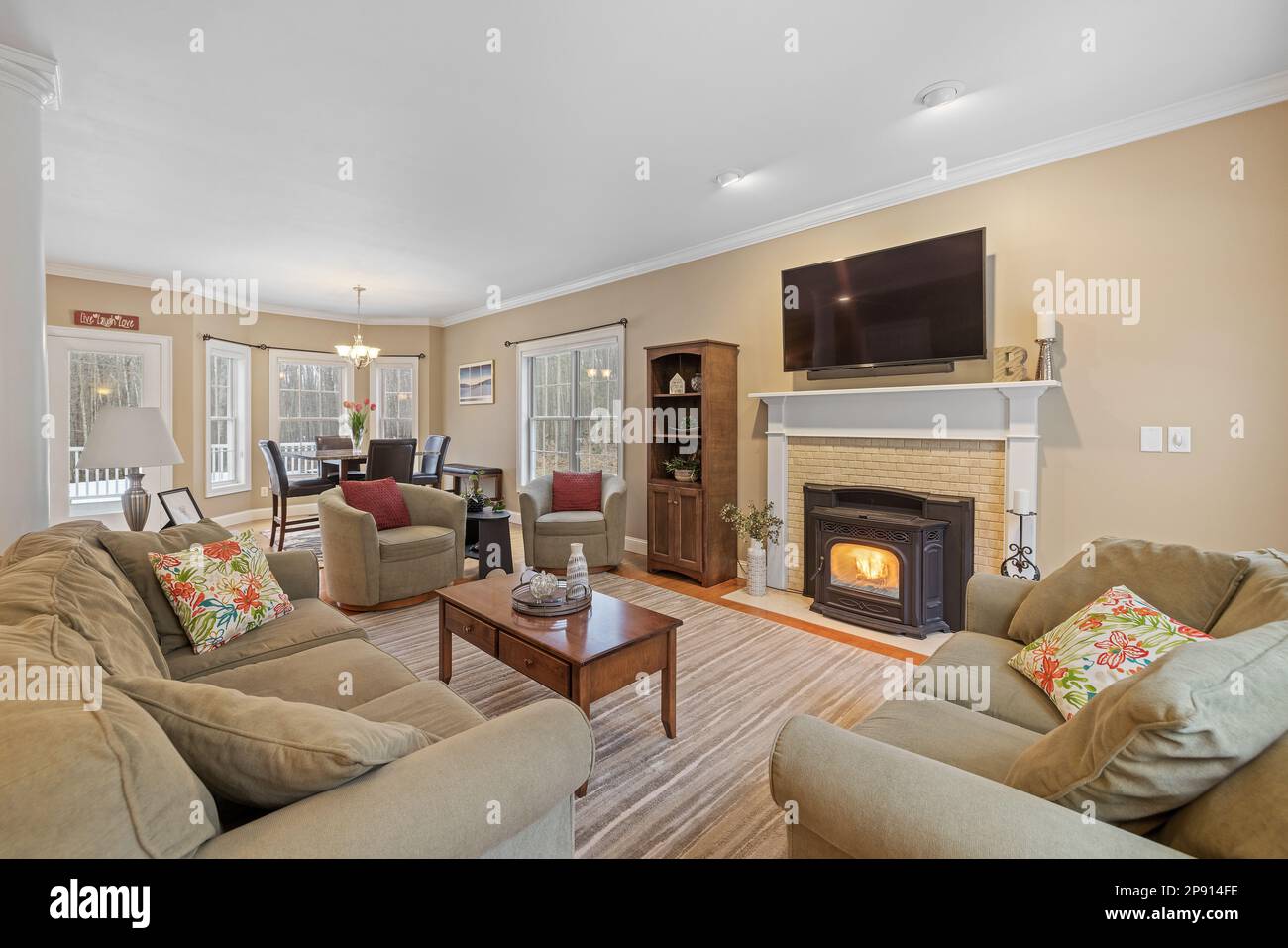 An inviting living room featuring cozy seating and stylish tables, perfect for entertaining guests Stock Photo