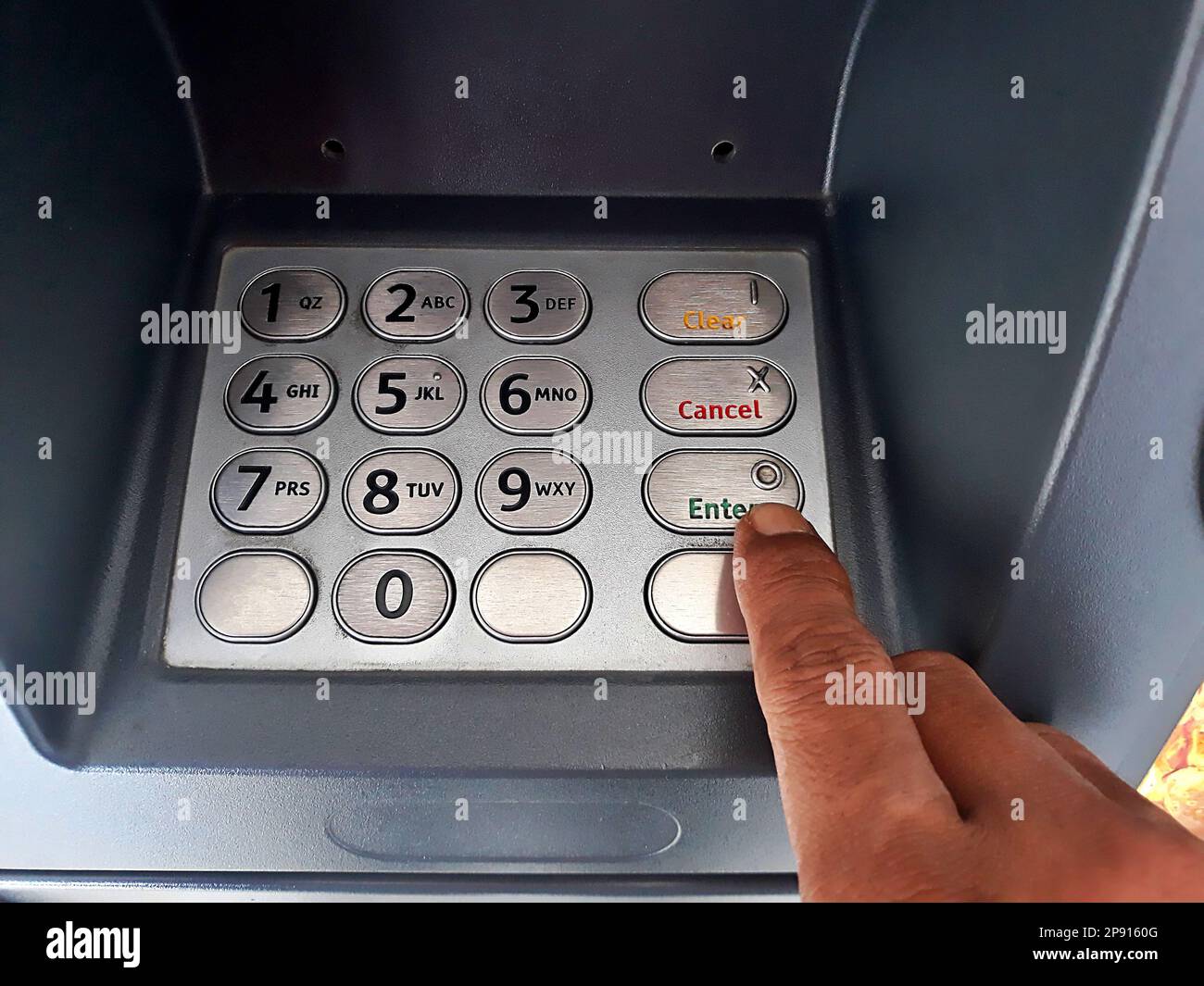 Close up the atm machine number buttons for money withdraw with indonesian money rupiah Stock Photo