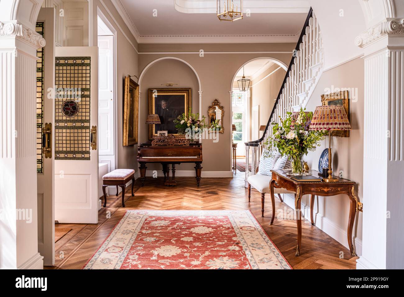 Patterned rug in doorway of 18th century Grade II listed Suffolk country house, UK Stock Photo