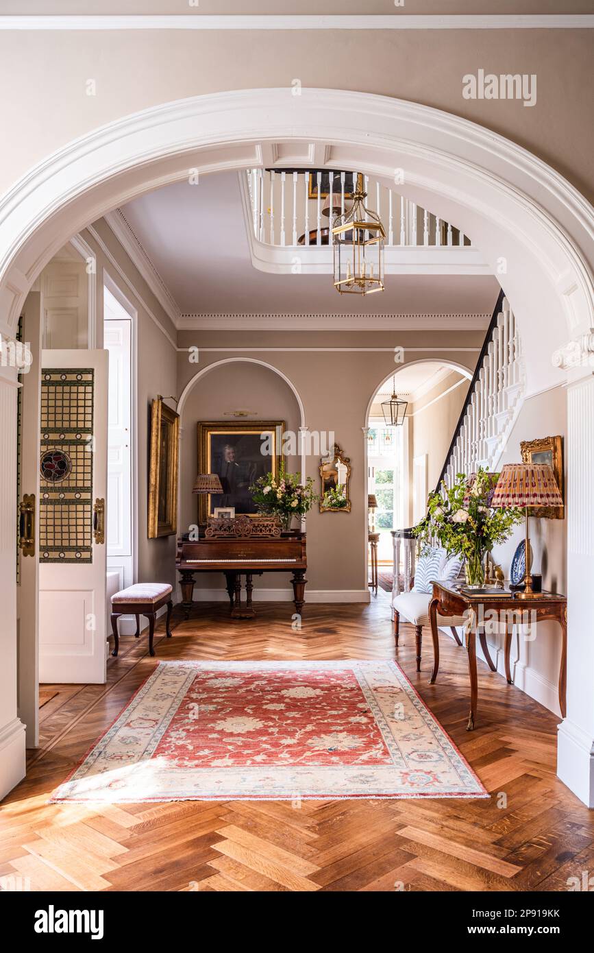 Patterned rug in entrance hall of renovated 18th century Grade II listed Suffolk country house, UK Stock Photo