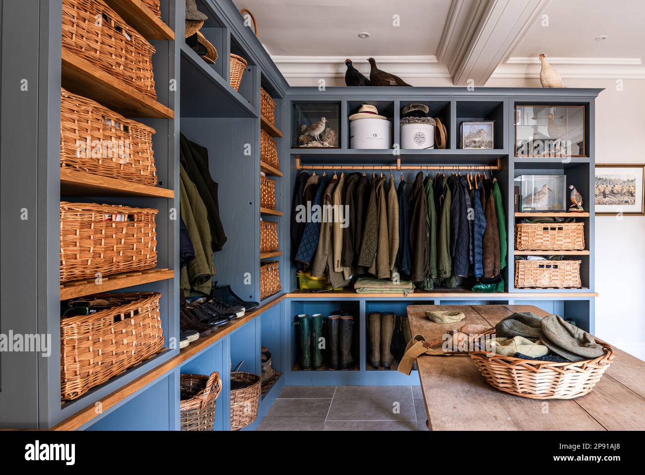 18thBootroom with baskets and coats in 18th century Grade II listed Suffolk country house, UK Stock Photo