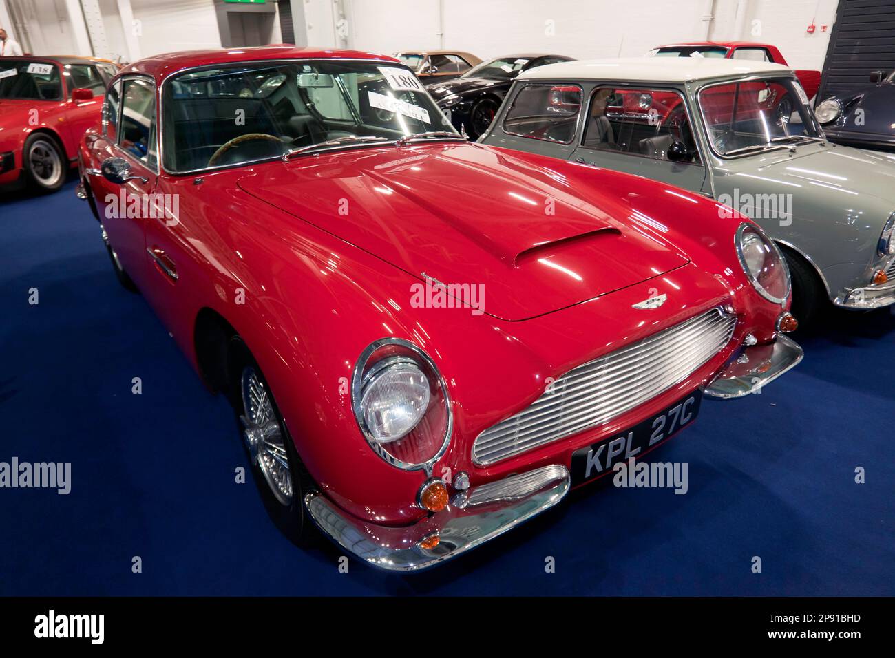 Three-Quarter Front view of a Red, 1965, Aston Martin DB6,  part of the 2023 London Classic Car Auction  at Olympia, London Stock Photo