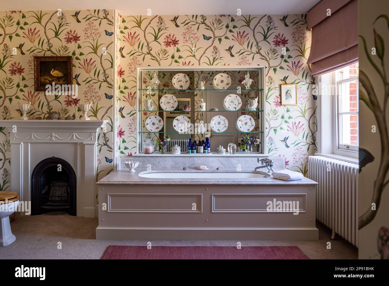 Sanderson wallpaper with plates displayed on mirrored shelves in18th century Grade II listed Suffolk country house, UK Stock Photo