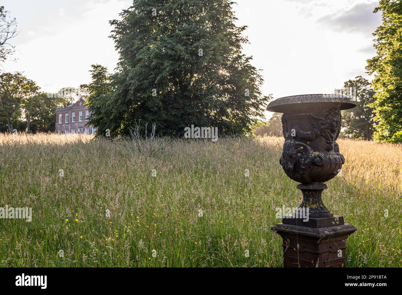 Antique urn in wild grassland of 18th century Grade II listed Suffolk