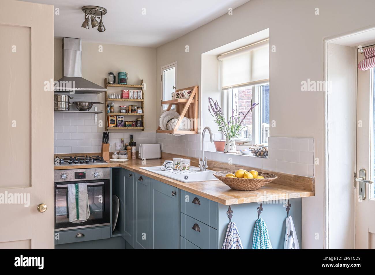 Kitchen redesign with stainless steel extractor and plate rack, units