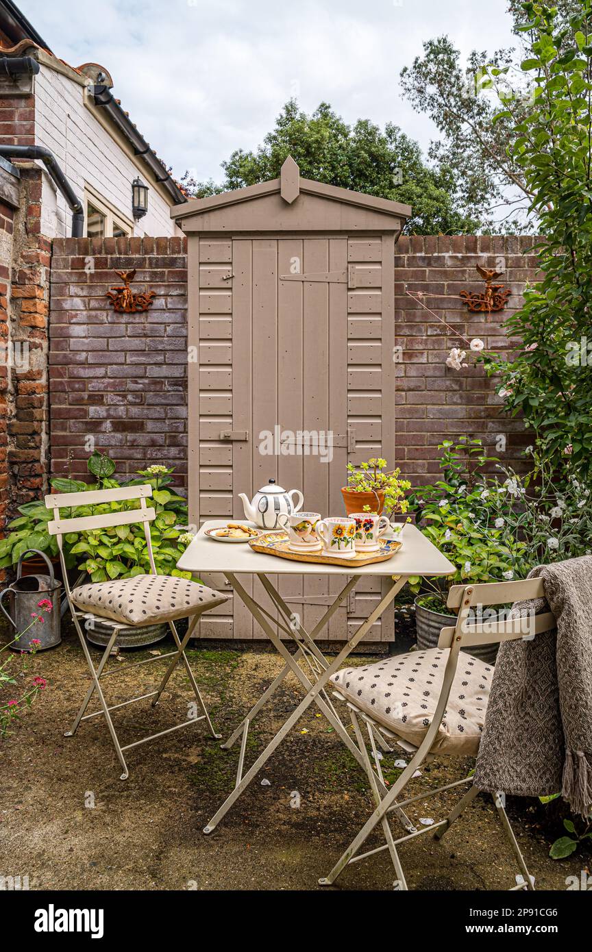 Secluded courtyard garden of 19th century Norfolk cottage, UK Stock Photo