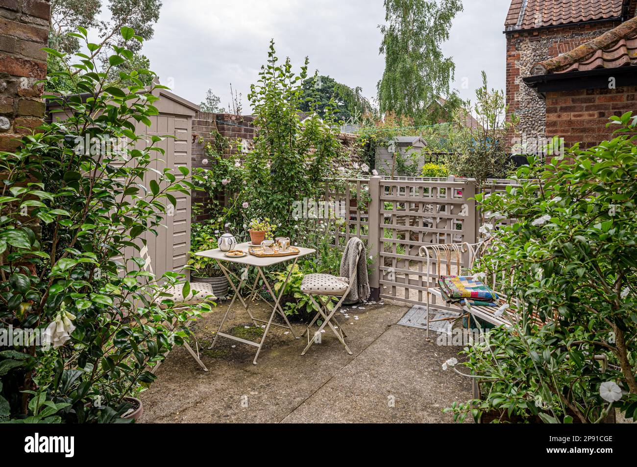 Secluded courtyard garden of 19th century Norfolk cottage, UK Stock Photo
