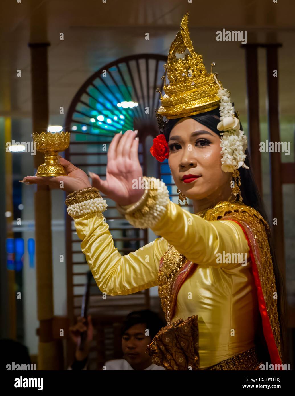 A traditional Khmer dancer in Cambodia performs on a river cruise ship moored in the capital Phnom Penh. Stock Photo