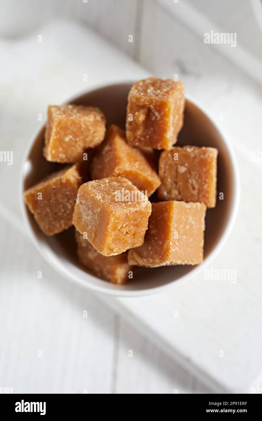 Close up brown cane sugar on white background, selective focus Stock Photo