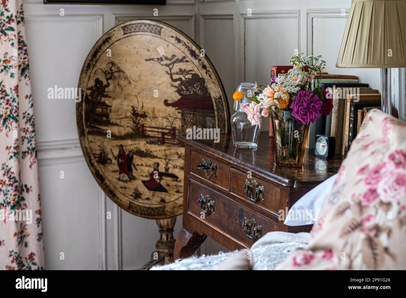 Chinoiserie table at bedside in Wiveton Hall 17th century Jacobean manor house, Norfolk, UK Stock Photo