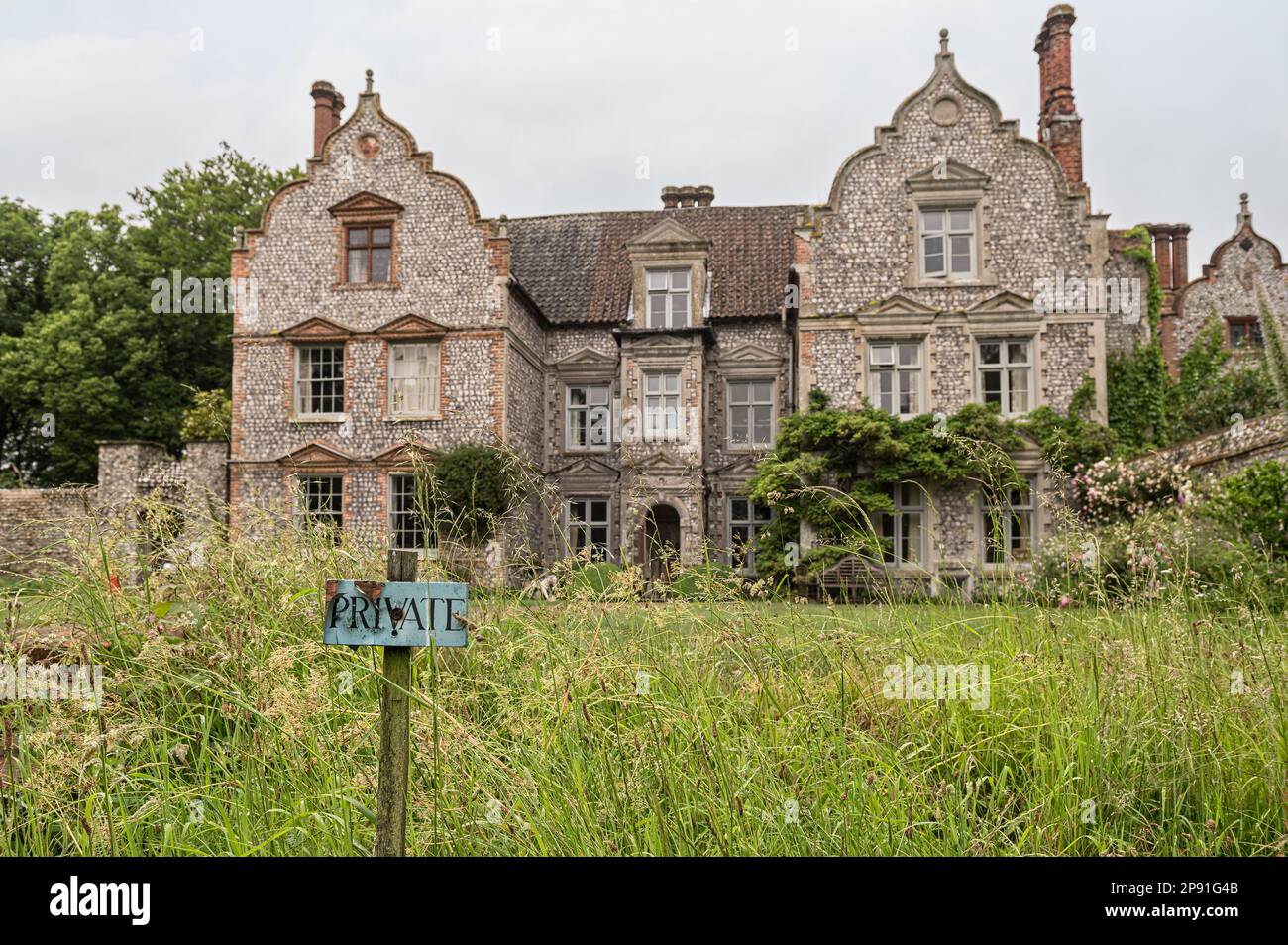 Private grounds of flint exterior of 17th century Jacobean manor house Wiveton Hall in Norfolk, UK Stock Photo