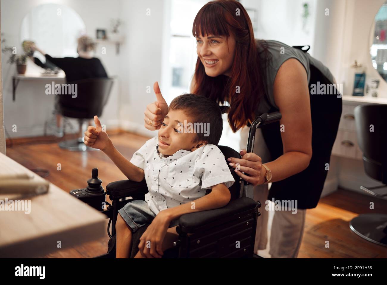 Hair salon, hairdresser and child in wheelchair with thumbs up after