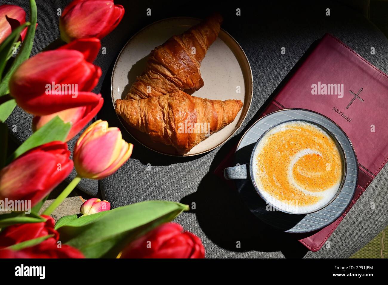 Spring Background with Tulips, Cappuccino Coffee Cup On Bible Stock Photo